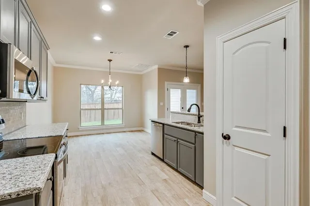 a spacious bathroom with a granite countertop sink a mirror and a bathtub