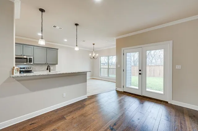 a large kitchen with stainless steel appliances granite countertop a large window a sink and a refrigerator