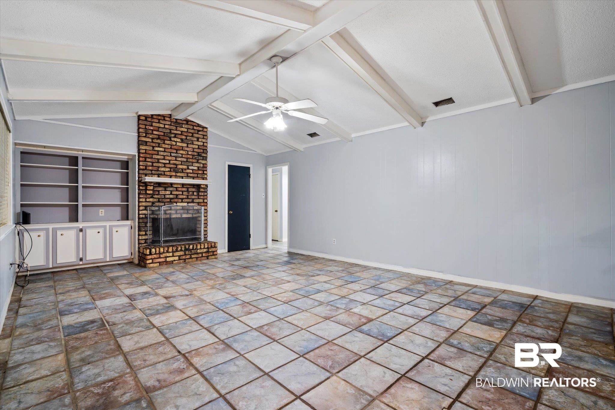 6657 Hounds Run South Mobile, AL 36608 - Photo 8 of 20 Unfurnished living room featuring a textured ceiling, built in features, a brick fireplace, lofted ceiling with beams, and ceiling fan