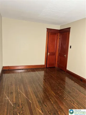 a view of an empty room and wooden floor