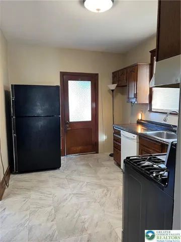 a kitchen with a refrigerator stove and cabinets