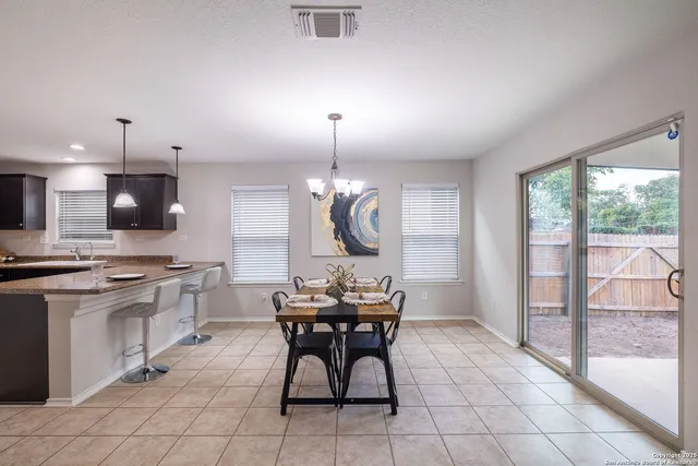 a kitchen with kitchen island granite countertop a stove a sink and a refrigerator