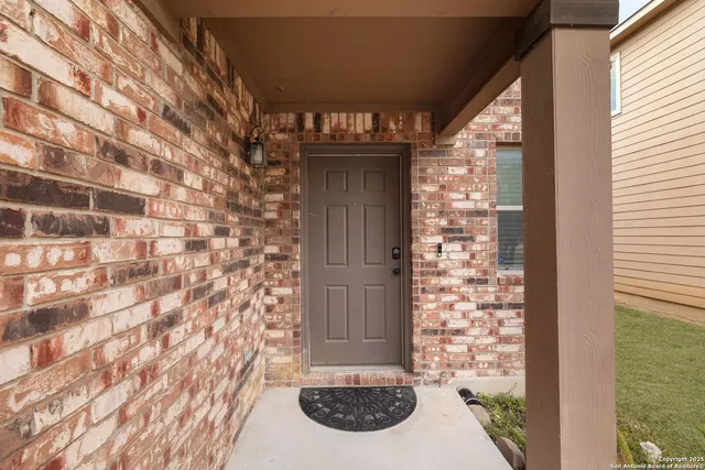 a view of a door and brick wall