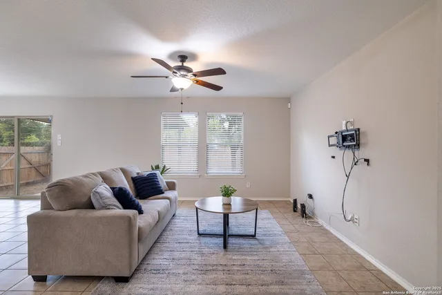 a living room with furniture a chandelier and a window