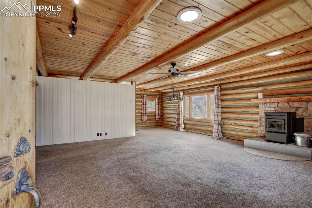 7915 Topeka Avenue Cascade, CO 80809 - Photo 11 of 36 a view of an empty room with a fireplace