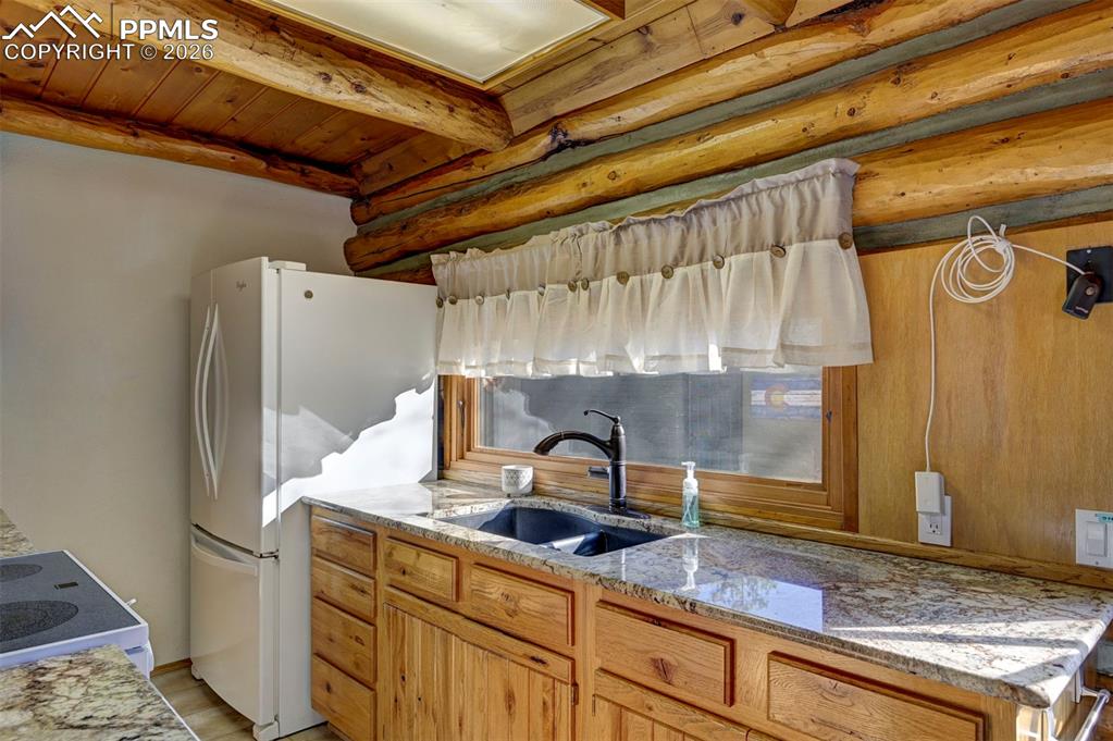 7915 Topeka Avenue Cascade, CO 80809 - Photo 17 of 36 a bathroom with a granite countertop sink and a mirror