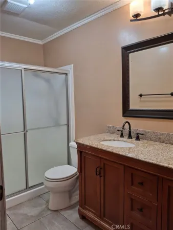 a white toilet sitting next to a bathroom sink