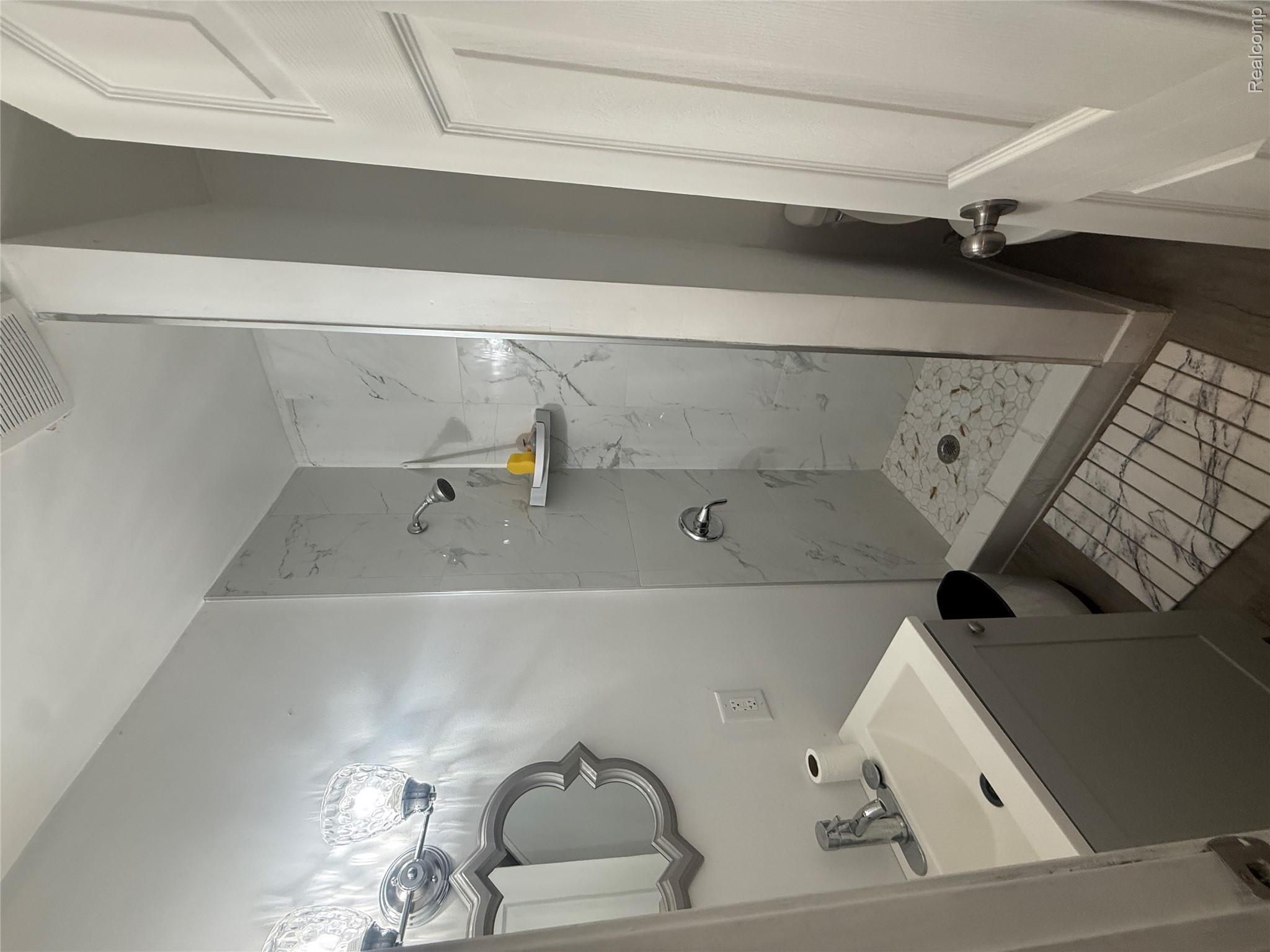 44862 Willis Road Belleville, MI 48111 - Photo 9 of 14 Bathroom with vanity and a marble finish shower