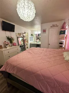 a bedroom with a bed and a chandelier