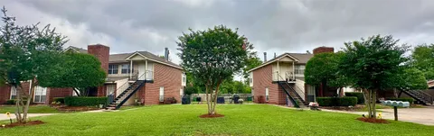 a garden with trees in front of it