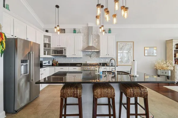 a kitchen with stainless steel appliances granite countertop a stove and refrigerator