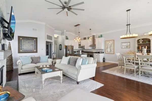 a living room with furniture and a chandelier