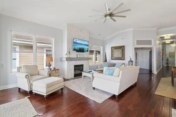 a living room with furniture a fireplace and a large window