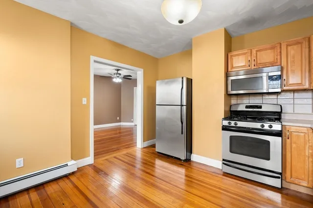 a kitchen with stainless steel appliances a refrigerator stove and microwave