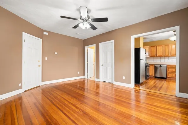 a view of an empty room with wooden floor