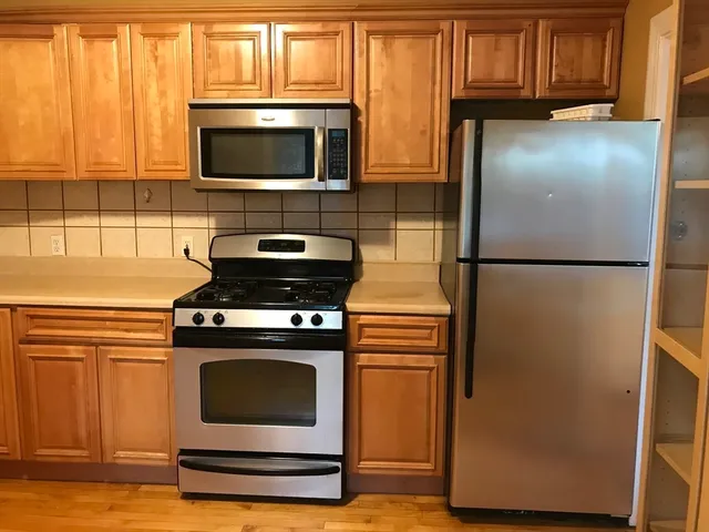 a stove top oven sitting inside of a kitchen