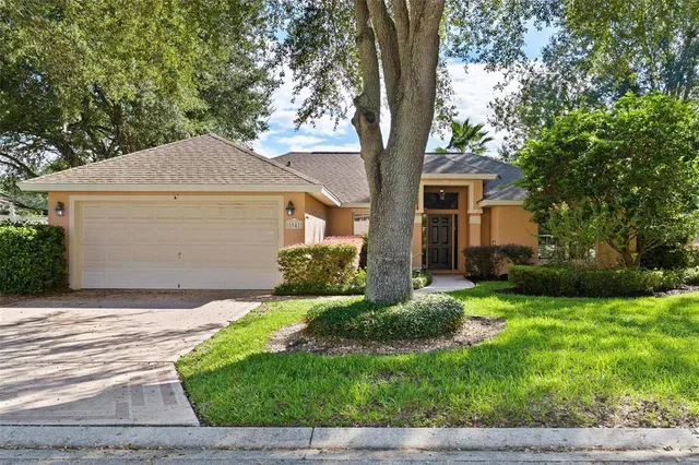a front view of house with yard and green space
