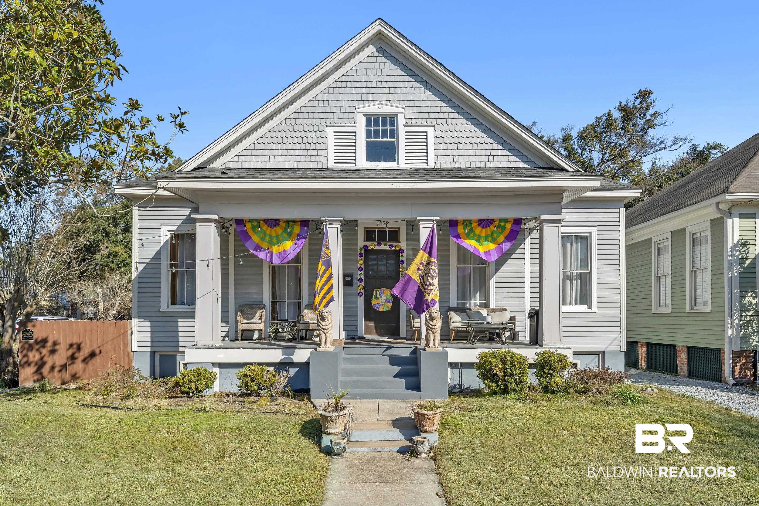 1322 Dauphin Street Mobile, AL 36604 - Photo 1 of 21 View of front of property with covered porch, roof with shingles, and an attached garage