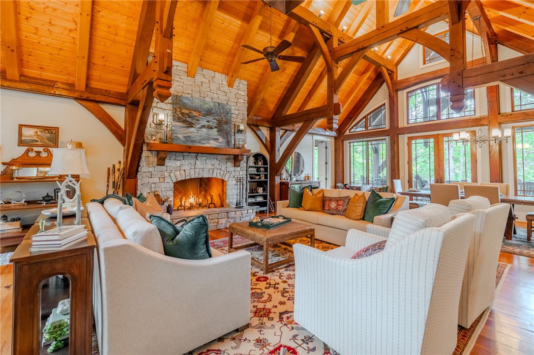 102 State Rd S-39-143 Sunset, SC 29685 - Photo 10 of 47 This inviting living room features high vaulted ceilings and a grand stone fireplace.