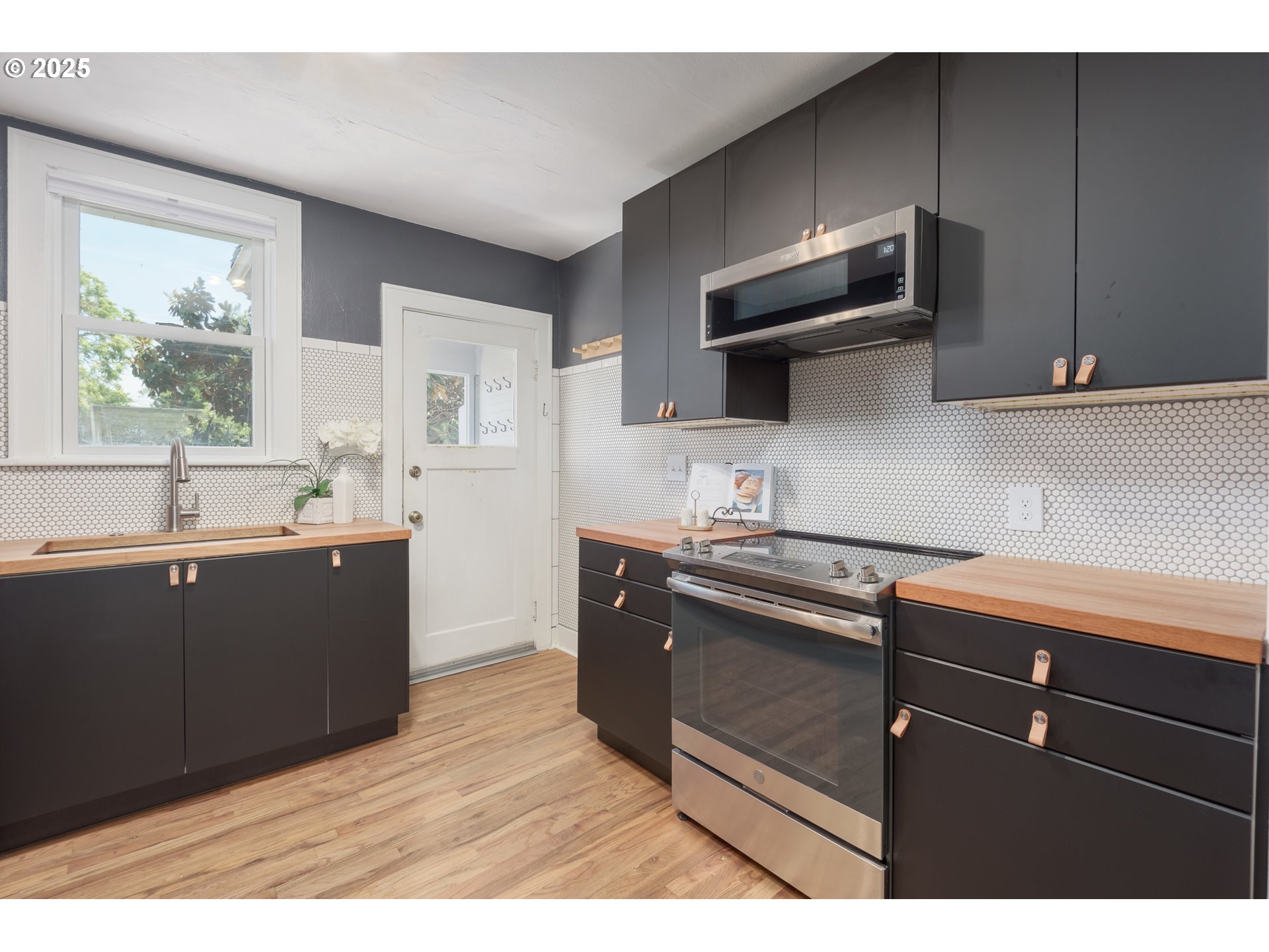 1681 Olive Street Eugene, OR 97401 - Photo 12 of 30 a kitchen with stainless steel appliances granite countertop a sink and a stove