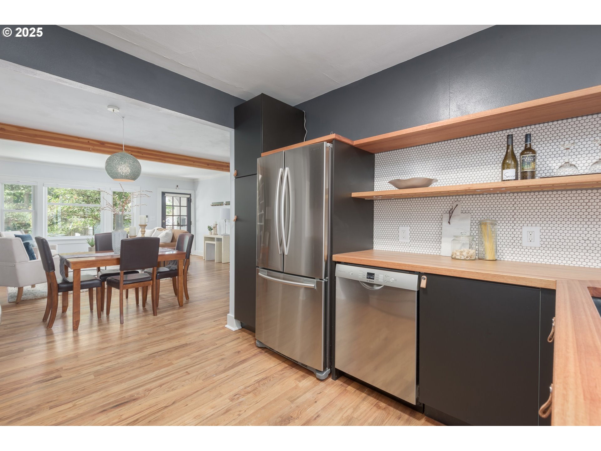1681 Olive Street Eugene, OR 97401 - Photo 14 of 30 a kitchen with stainless steel appliances granite countertop a refrigerator a sink a stove and a dining table with wooden floor