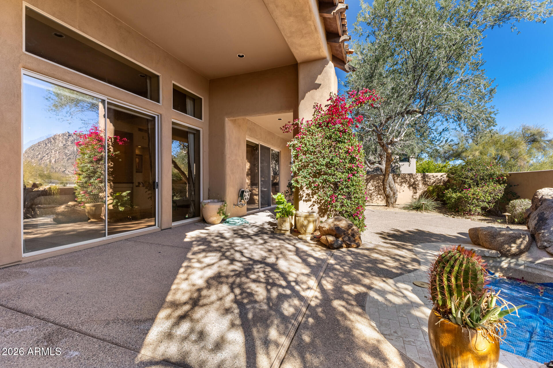 10040 East Happy Valley Road, Unit 2057 Scottsdale, AZ 85255 - Photo 21 of 21 a flower garden is sitting in front of a house