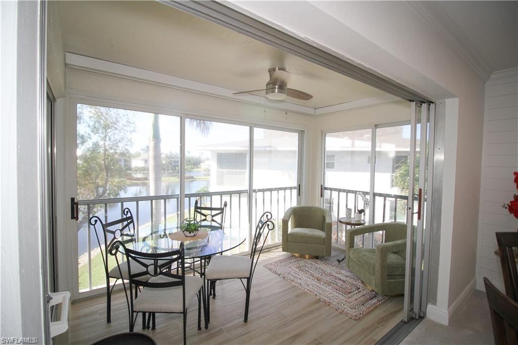 97 Georgetown Boulevard, Unit 97 Naples, FL 34112 - Photo 11 of 25 a view of a dining room with furniture window and outside view