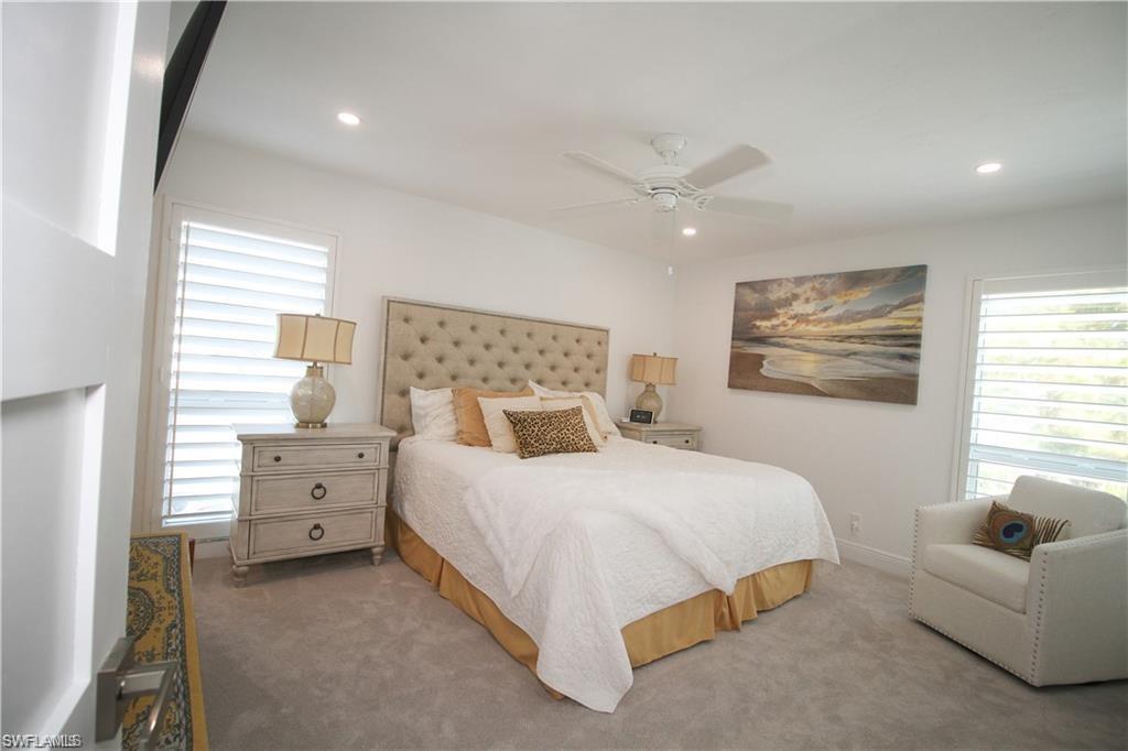 97 Georgetown Boulevard, Unit 97 Naples, FL 34112 - Photo 14 of 25 a bedroom with a bed and a couch