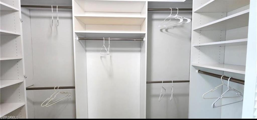 97 Georgetown Boulevard, Unit 97 Naples, FL 34112 - Photo 17 of 25 a view of walk in closet with empty racks