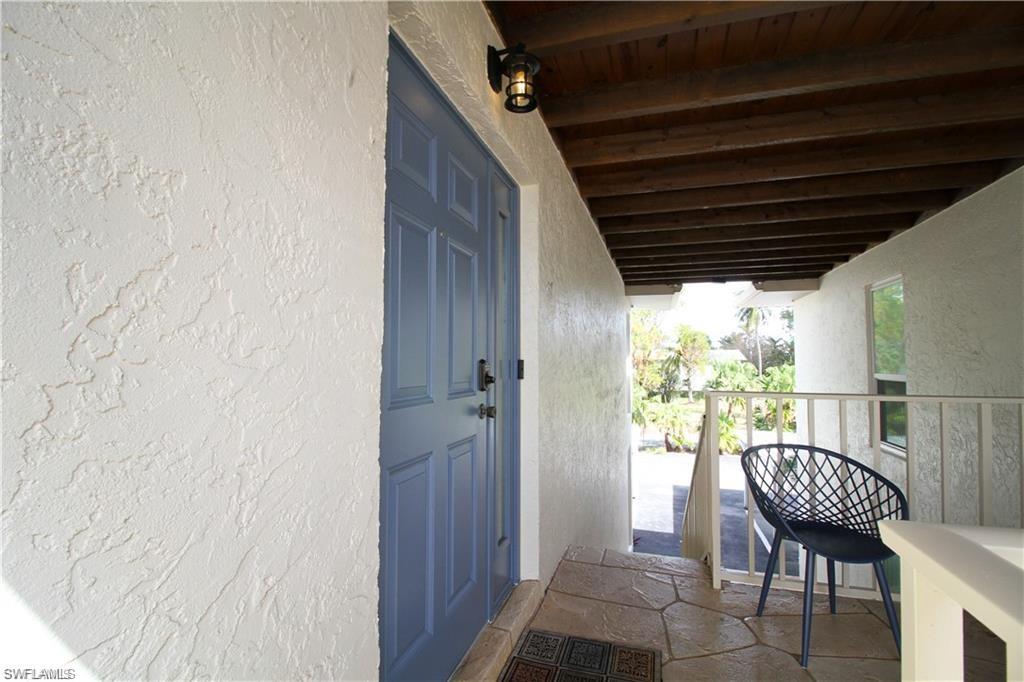 97 Georgetown Boulevard, Unit 97 Naples, FL 34112 - Photo 4 of 25 a view of a balcony with table & chairs
