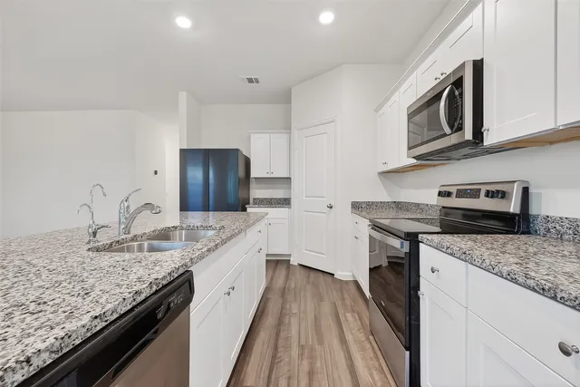 a kitchen with granite countertop cabinets and sink
