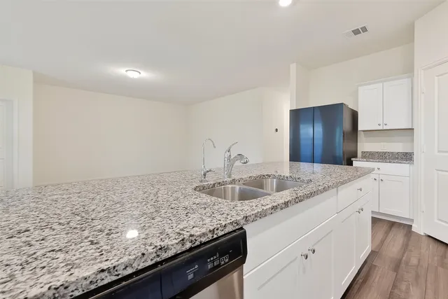 a kitchen with granite countertop stainless steel appliances and cabinets