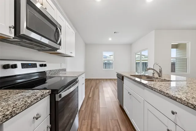 a kitchen with a stove and a microwave