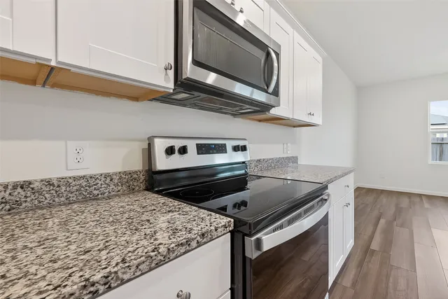 a kitchen with a stove and a microwave