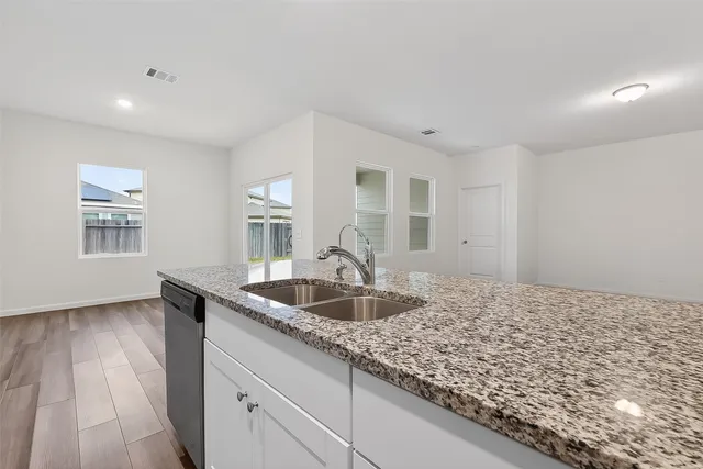 a kitchen with granite countertop kitchen island sink and granite counter tops