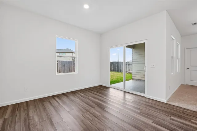 a view of a room with wooden floor and white walls