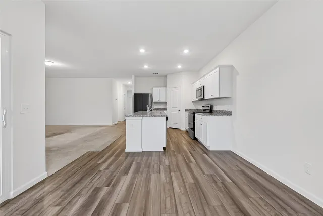 a view of kitchen with cabinets and wooden floor