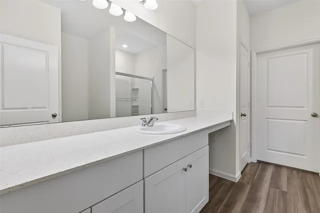 a bathroom with a double vanity sink and a mirror