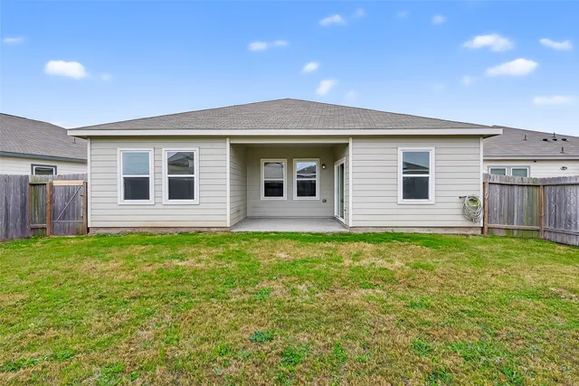 a view of a house with a backyard