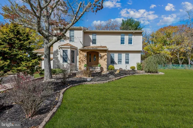 a view of a house with backyard sitting area and garden