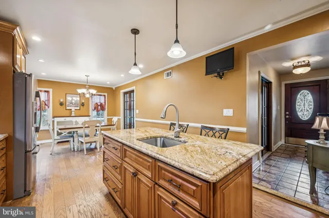 a kitchen with stainless steel appliances granite countertop sink stove top oven and cabinets