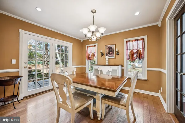 a view of a dining room with furniture wooden floor and chandelier