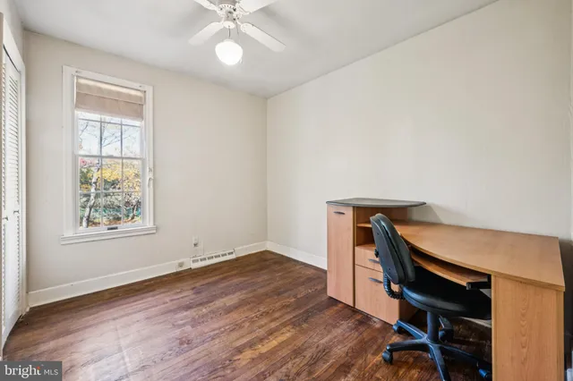 a view of room with window and wooden floor