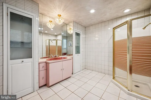 a large bathroom with a large mirror shower and vanity