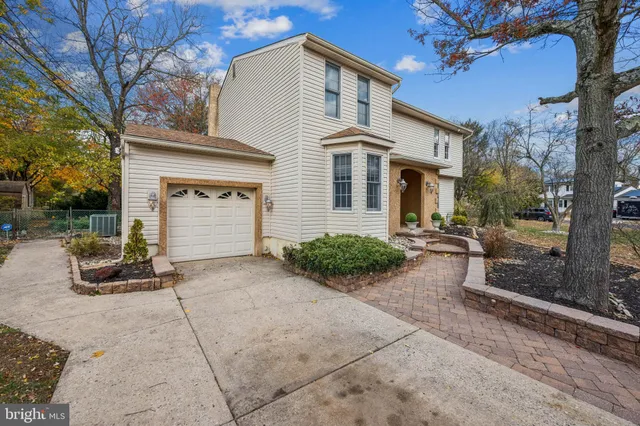 a view of a patio with couches and table and chairs under an umbrella