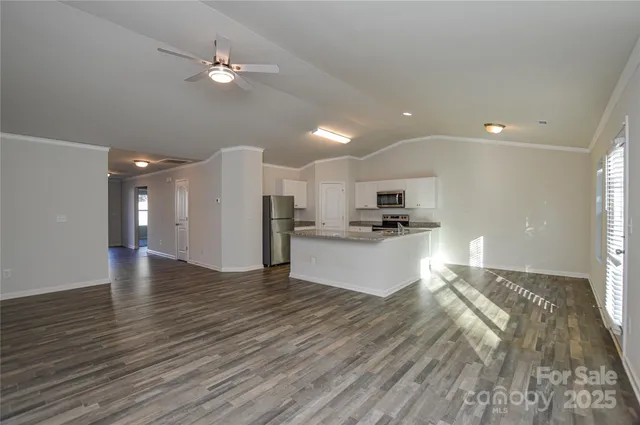 a kitchen with granite countertop kitchen island cabinets and stainless steel appliances