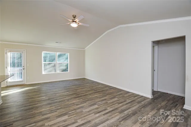 a large kitchen with kitchen island a sink dishwasher a stove and a refrigerator with wooden floor