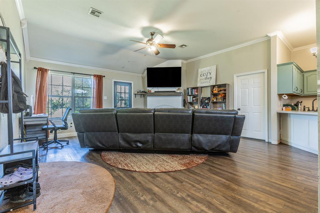 4930 Spring Valley Road Lorena, TX 76655 - Photo 2 of 34 Vaulted ceiling, wood-finish flooring, ceiling fan, built-in shelving, and a built-in mantel