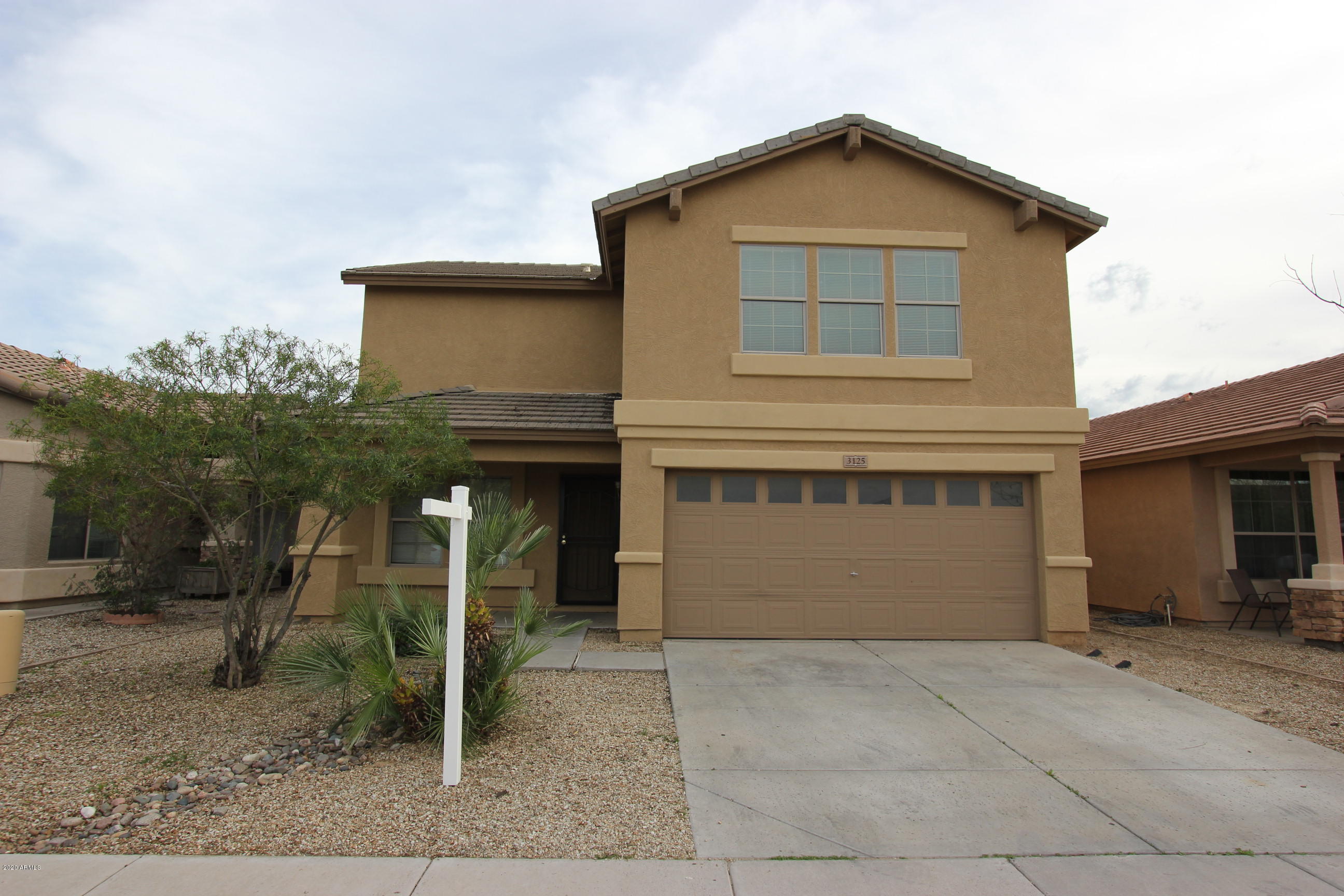 3125 West Fremont Rd. Phoenix, AZ 85041 - Photo 1 of 33 a front view of a house with a yard and garage
