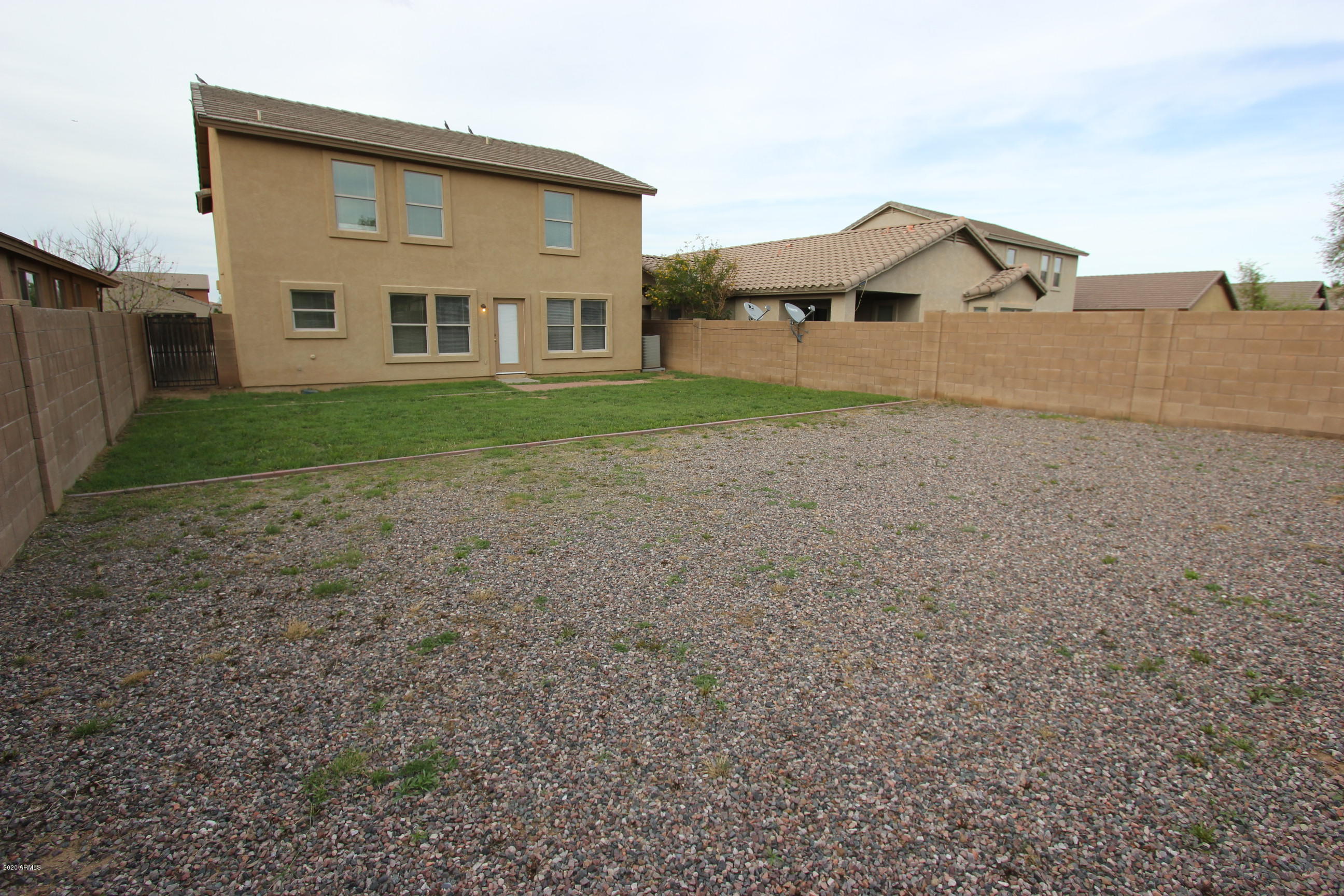 3125 West Fremont Rd. Phoenix, AZ 85041 - Photo 14 of 33 a front view of a house with a yard and garage